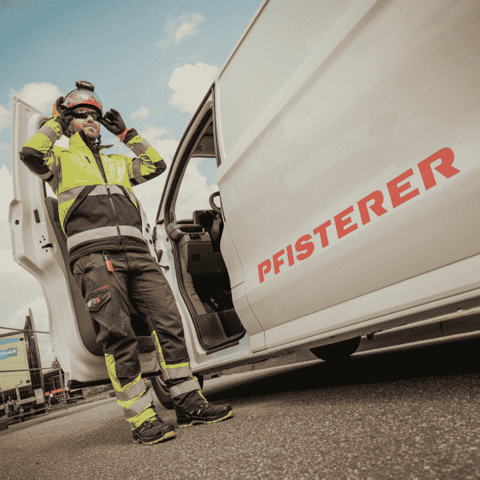 Mechanic standing in front of a PFISTERER car