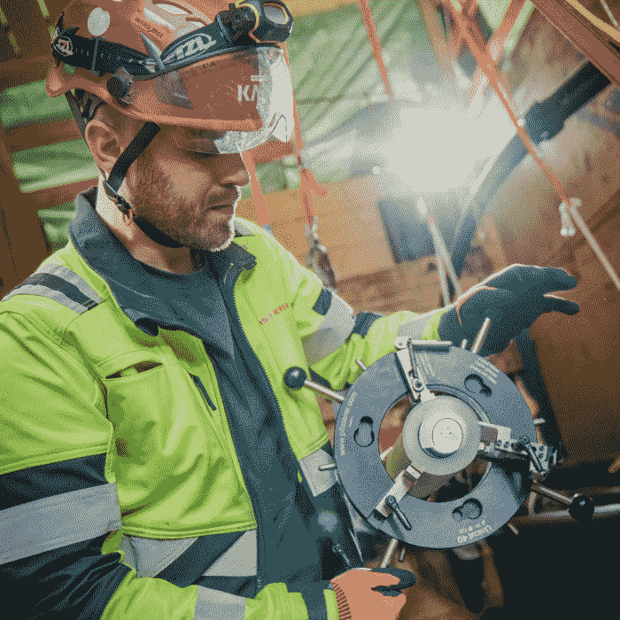 A technician stripping a cable