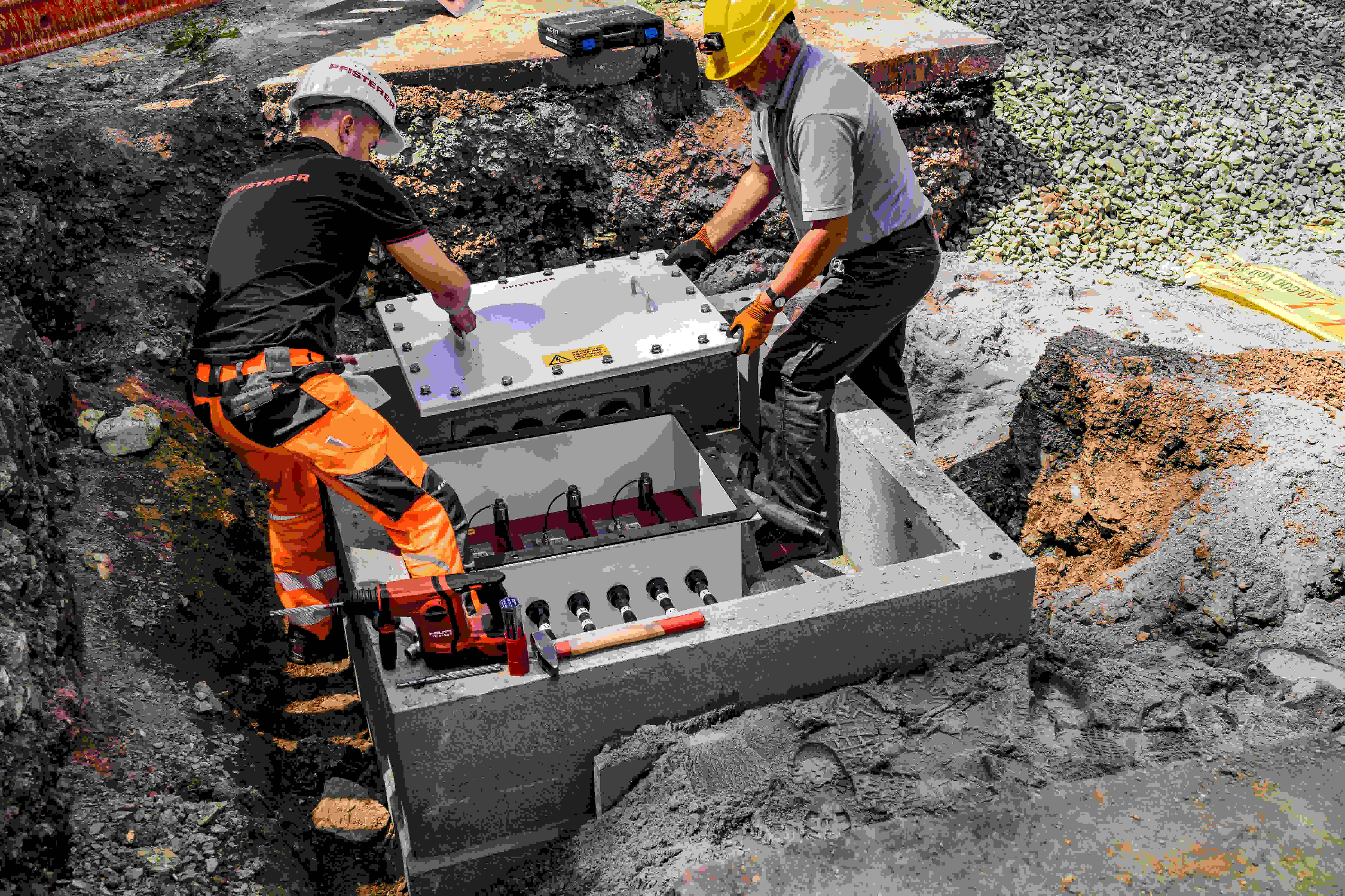 Two workers working at an open pit