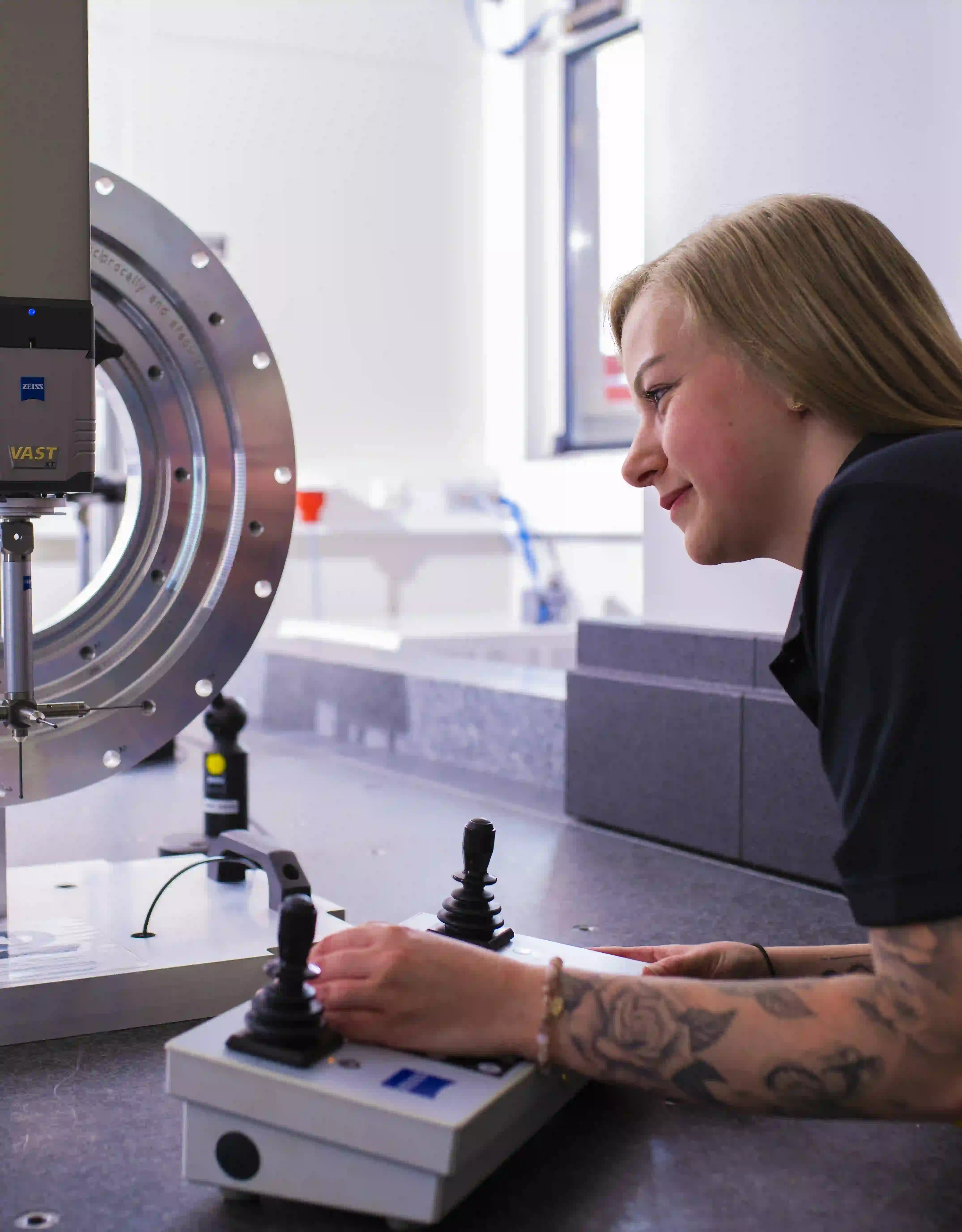 Employee at a machine with steering devices
